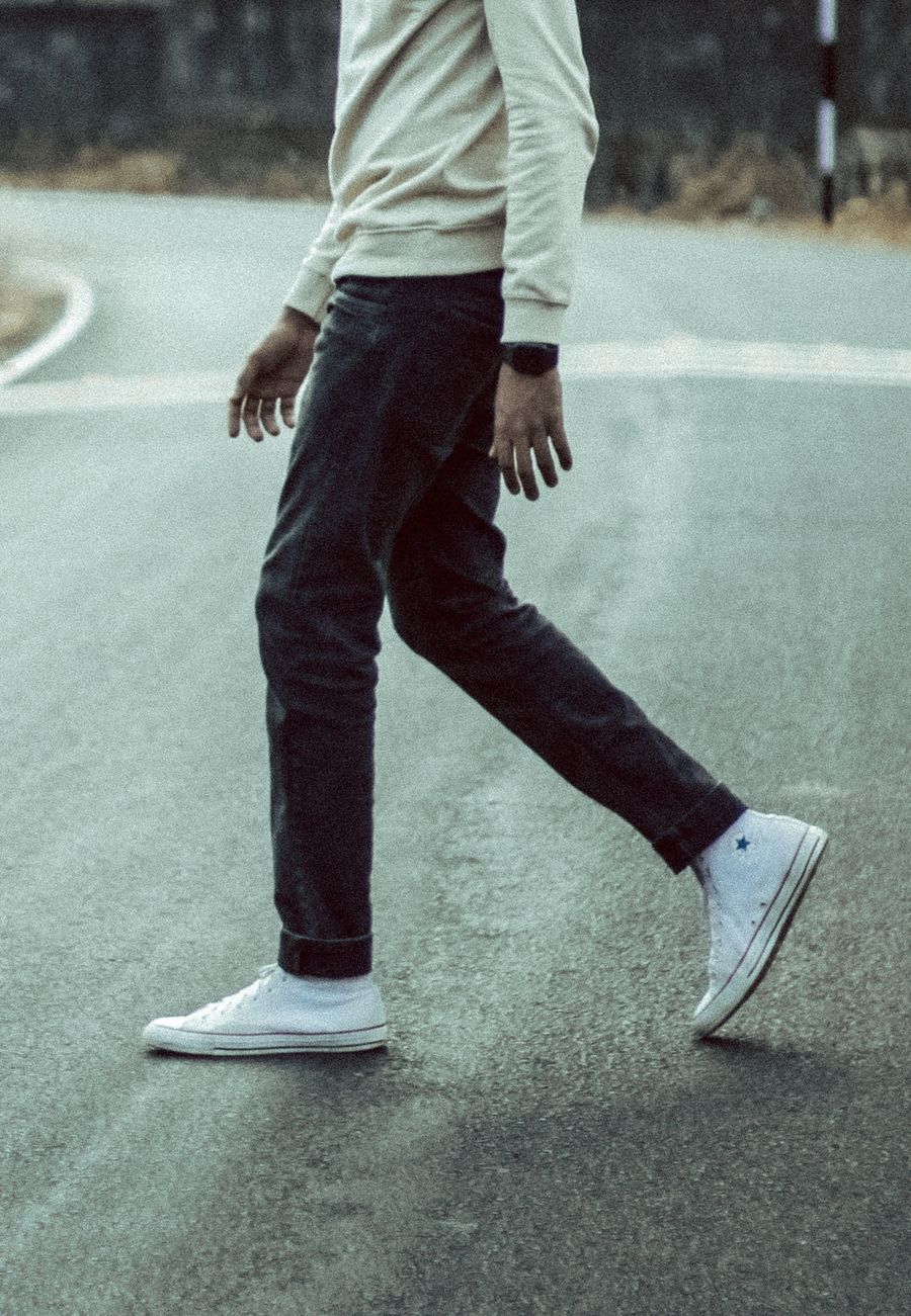 Man walking along a city street on a long day out
