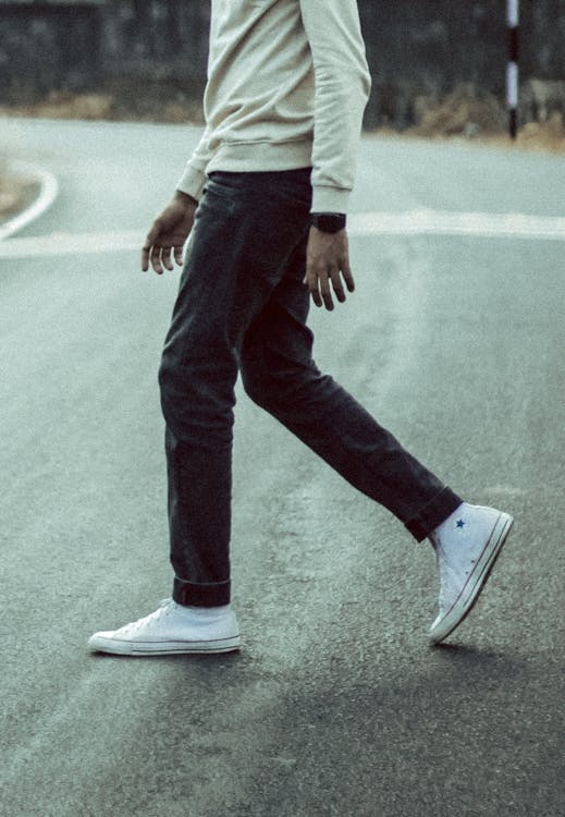 Man in Jeans and Sneakers Walking Down the Street · Free Stock Photo