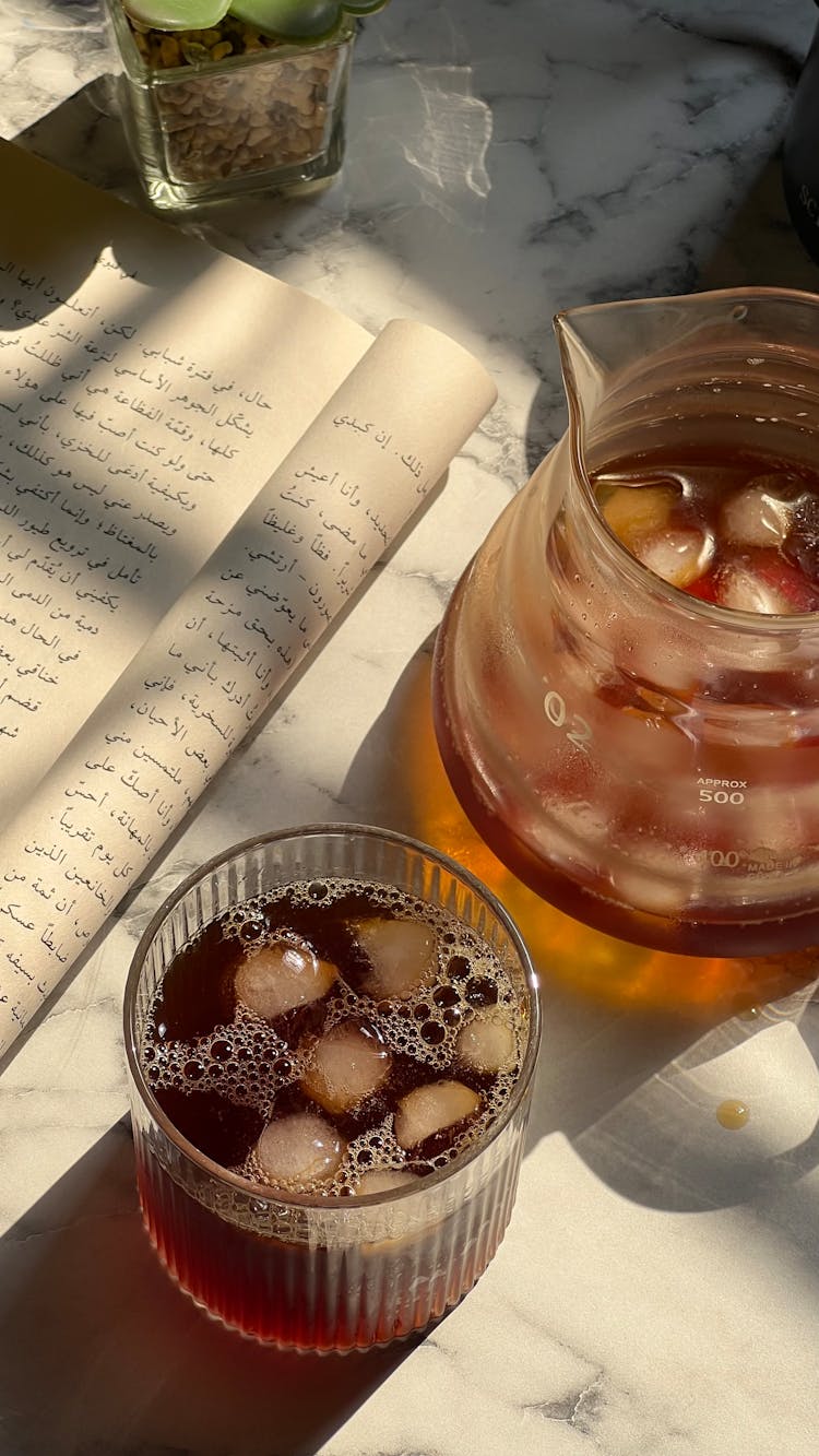 Pitcher And Glass Of Beverage With Ice