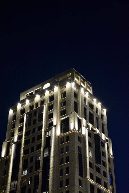 Free A brightly lit skyscraper in Astana, Kazakhstan, against a dark night sky. Stock Photo