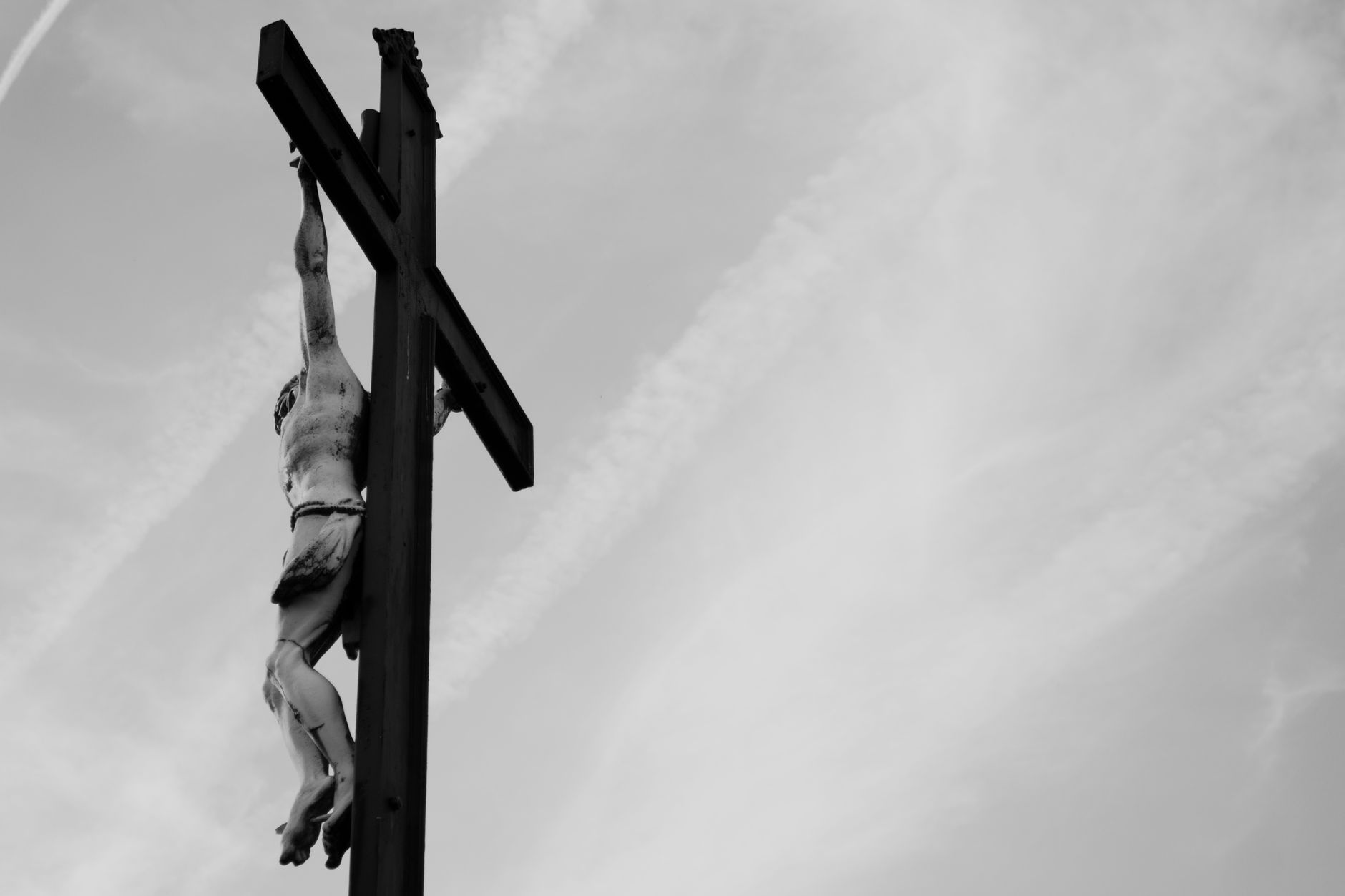 Dramatic black and white photo of Jesus Christ's crucifixion capturing religious symbolism.