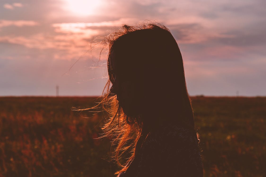 Woman's Silhouette Photo during Sunset · Free Stock Photo