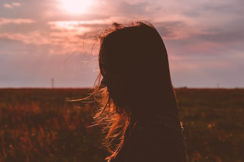 Woman's Silhouette Photo during Sunset