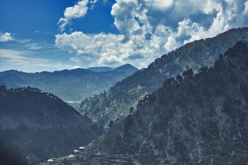 Free Picturesque view of the mountains in Katra under a clear blue sky with clouds. Stock Photo
