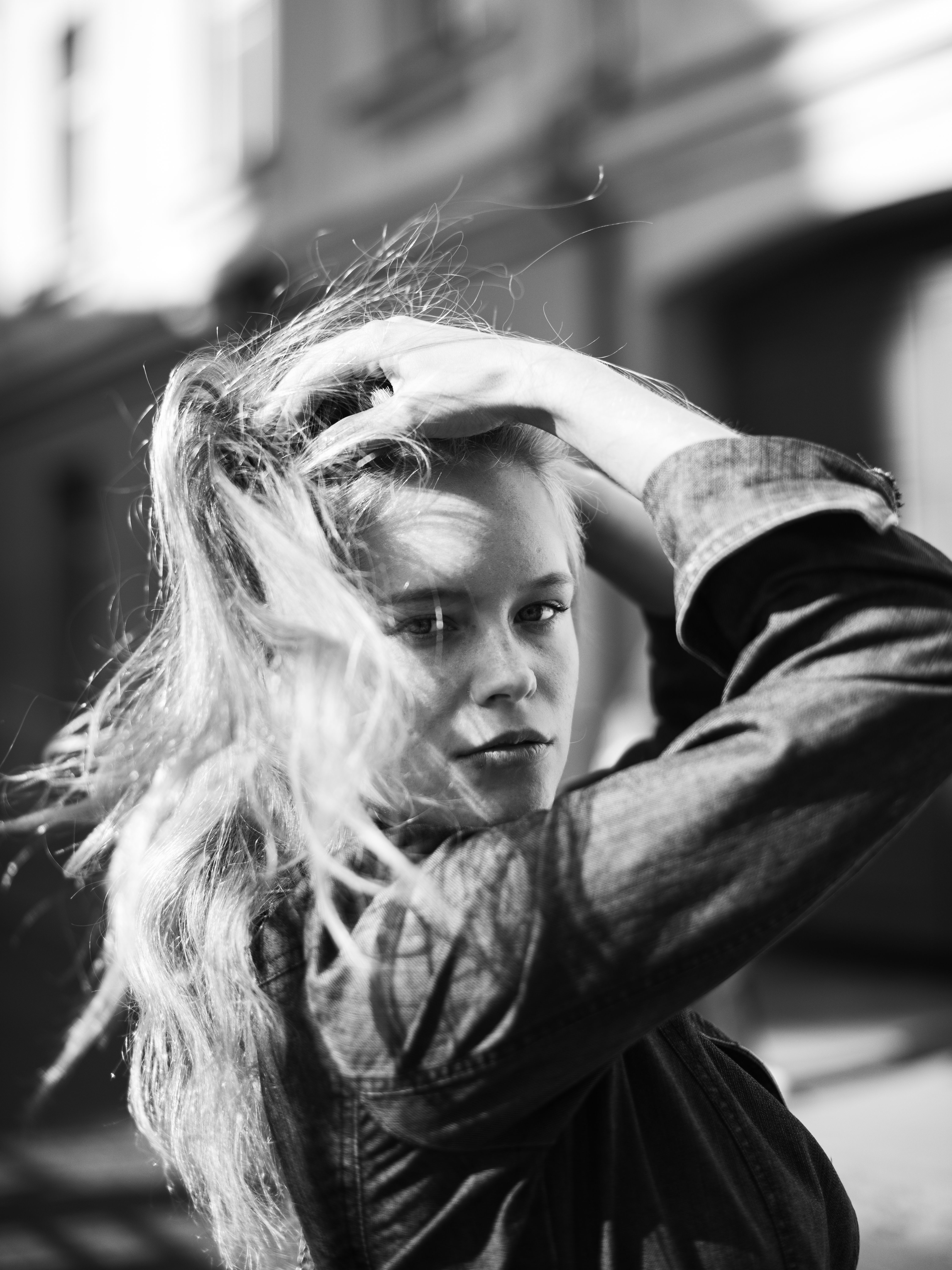 Artistic black and white portrait of a woman outdoors in Vilnius, Lithuania.
