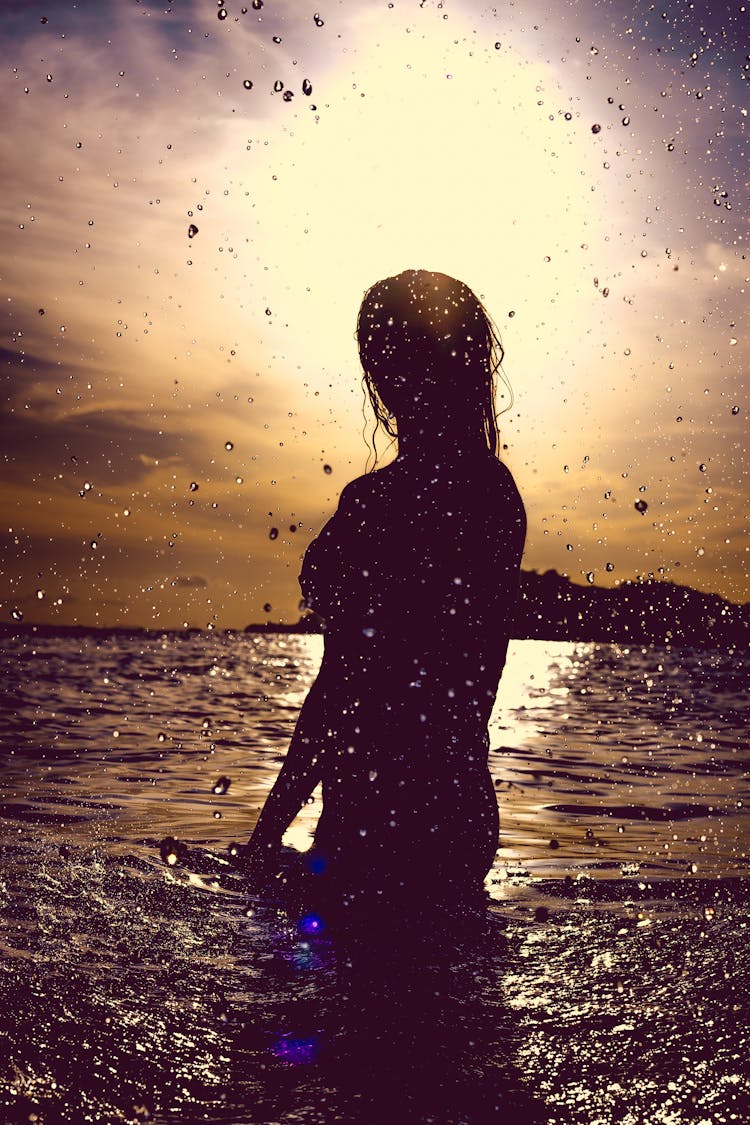 Silhouette Of Woman In Water