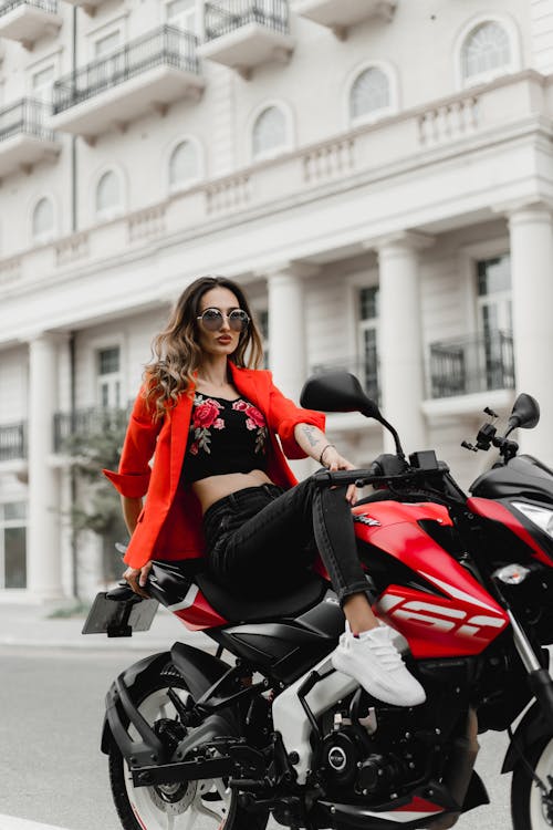 Woman in Red Suit Jacket Posing on Motorbike