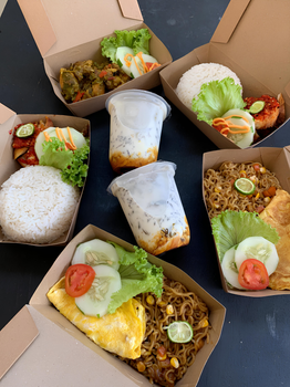 Assorted Asian boxed meals with rice, noodles, and fresh vegetables. Perfect for takeaway lunches.