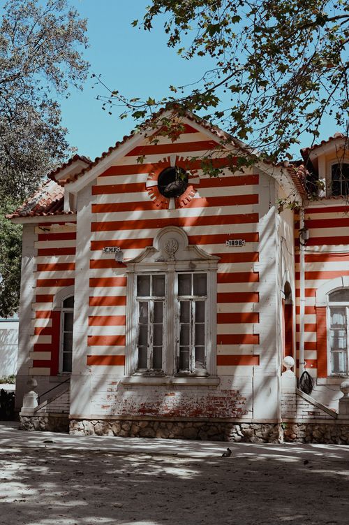 Free Charming red and white striped building facade in Faro, Portugal's Alameda Garden. Stock Photo