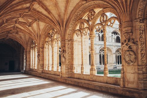 Free Beautiful and detailed stone arches in a historic cloister with stunning light play. Stock Photo