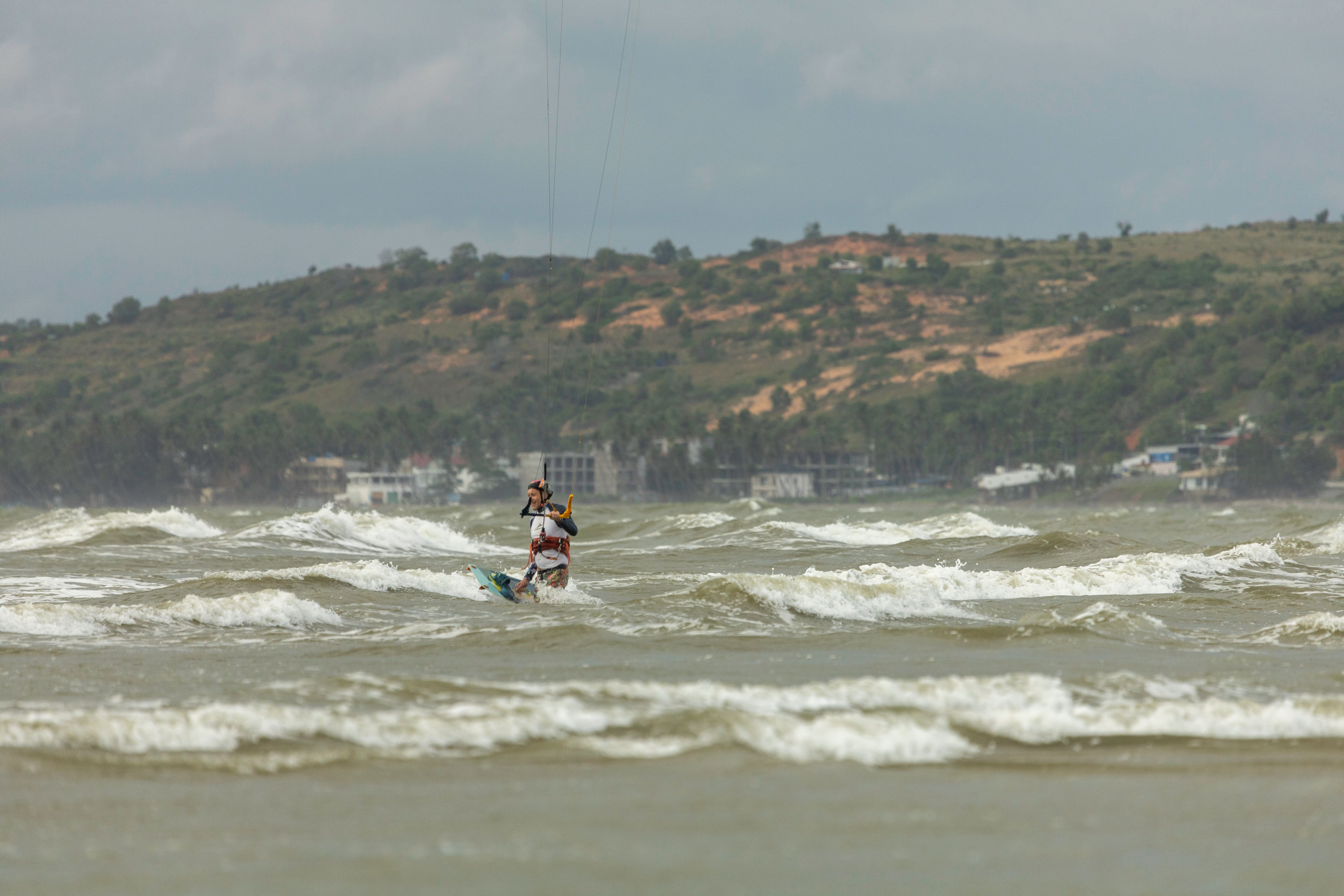 Experience the thrill of kitesurfing on a windy ocean, mastering the waves for ultimate recreation.