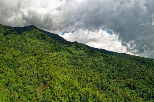Free Breathtaking view of lush green mountains under a cloudy sky in Majasari, Banten, Indonesia. Stock Photo