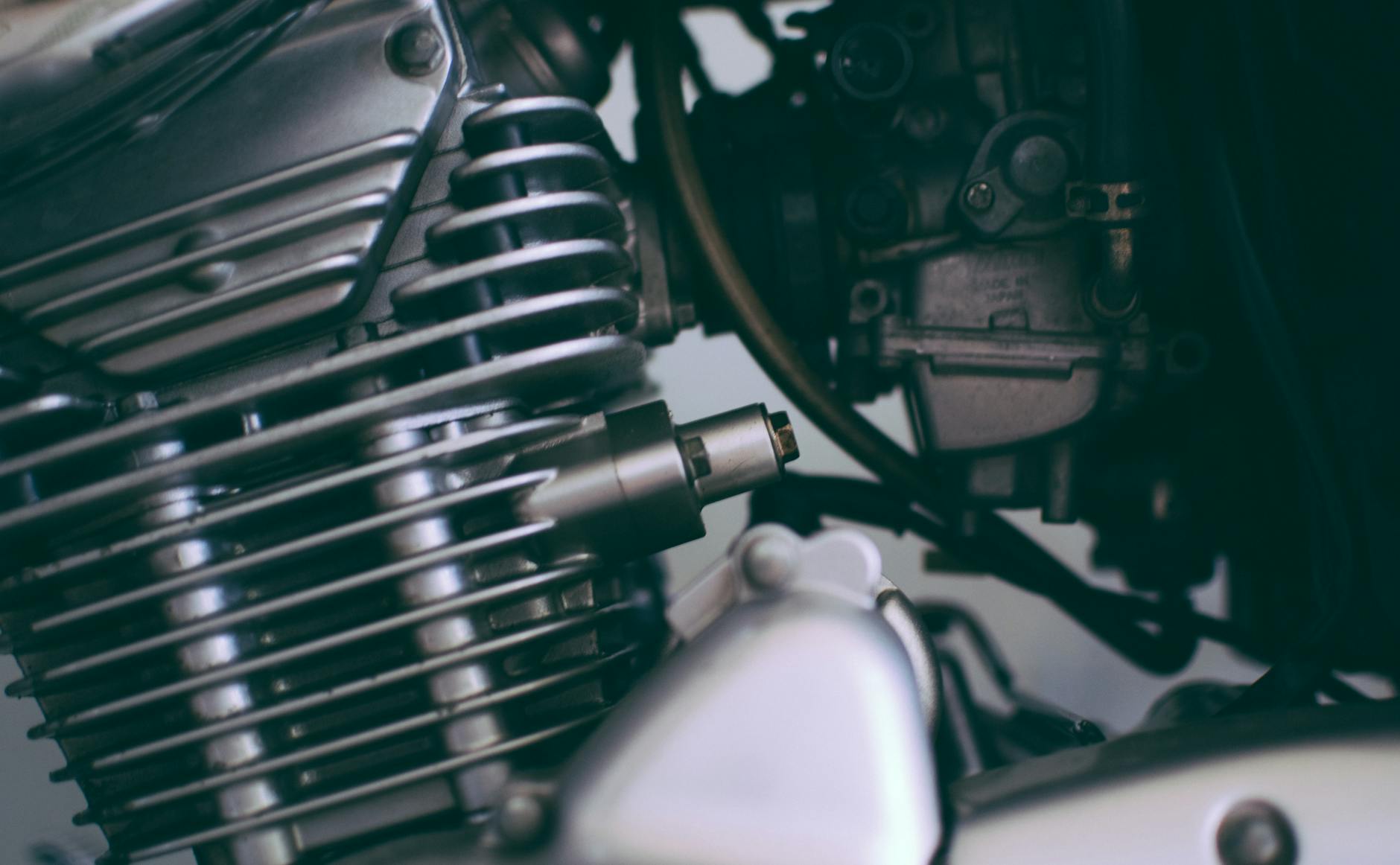 Detailed close-up of a shiny motorcycle engine showcasing metal components.
