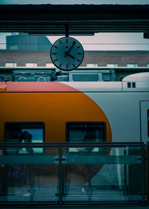 Free Contemporary railway station scene featuring a train and clock, signifying modern transportation. Stock Photo