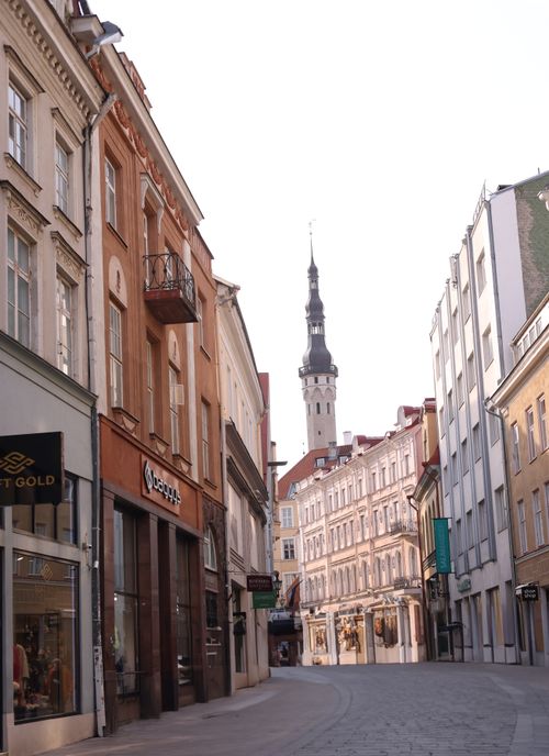 Free Charming view of Tallinn's old town street with iconic church tower. Stock Photo