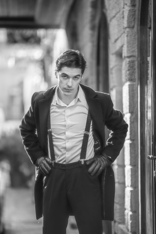 Free Black and white portrait of a stylish man posing outdoors in Baku, Azerbaijan. Stock Photo