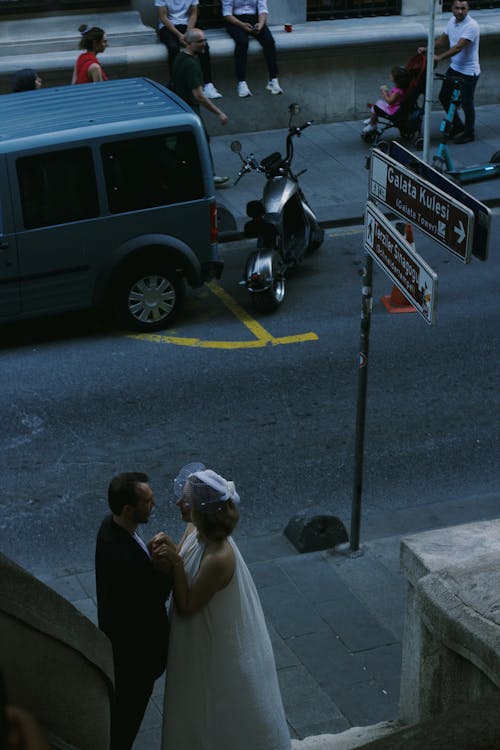 Newlywed Couple in City Sidewalk