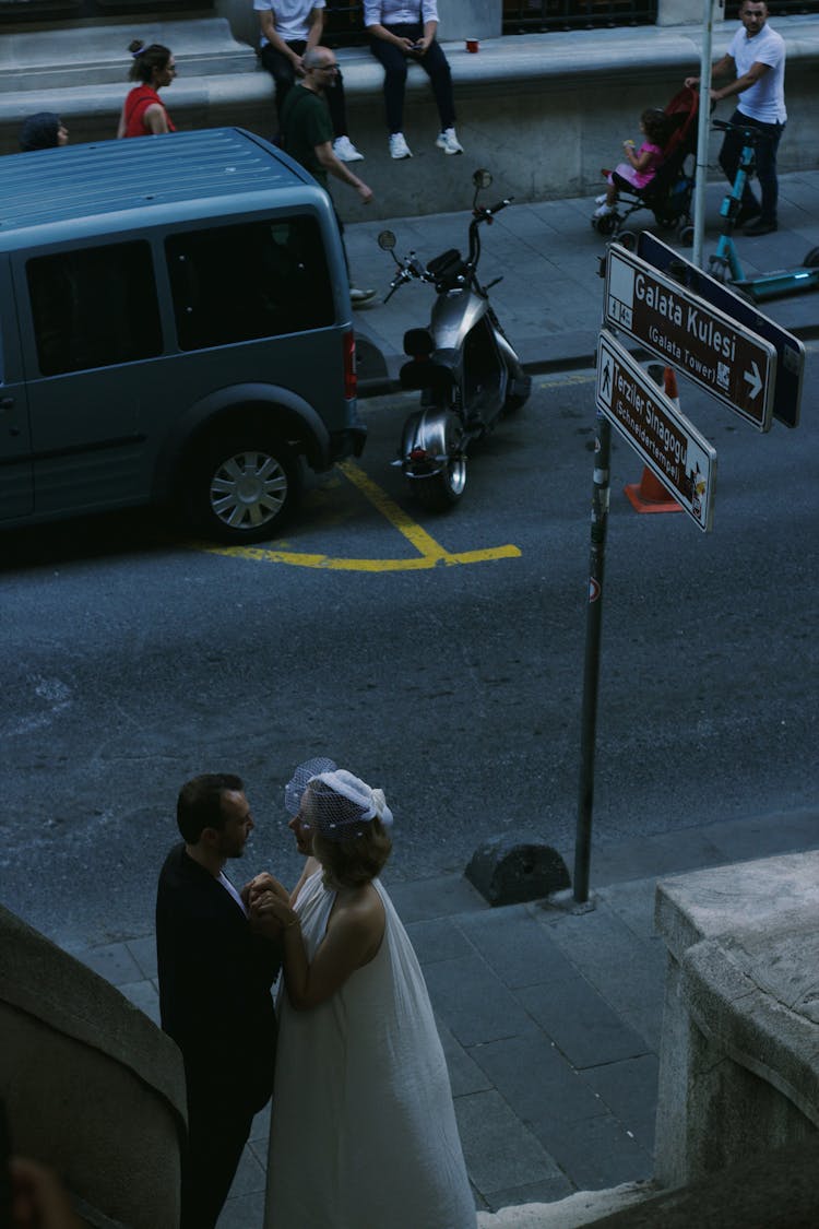 Newlywed Couple In City Sidewalk