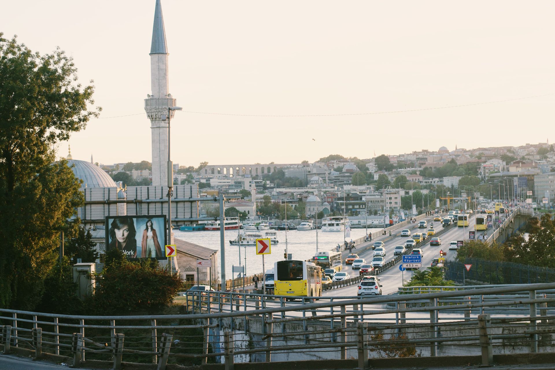 Dynamic view of Istanbul featuring traffic, a minaret, and vibrant urban life along the water.