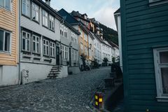 Charming cobblestone street lined with colorful historic houses on an uphill slope.