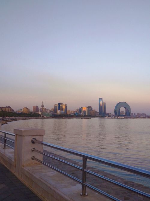 Free Skyline of Baku with modern architecture reflecting on the Caspian Sea at dawn. Stock Photo