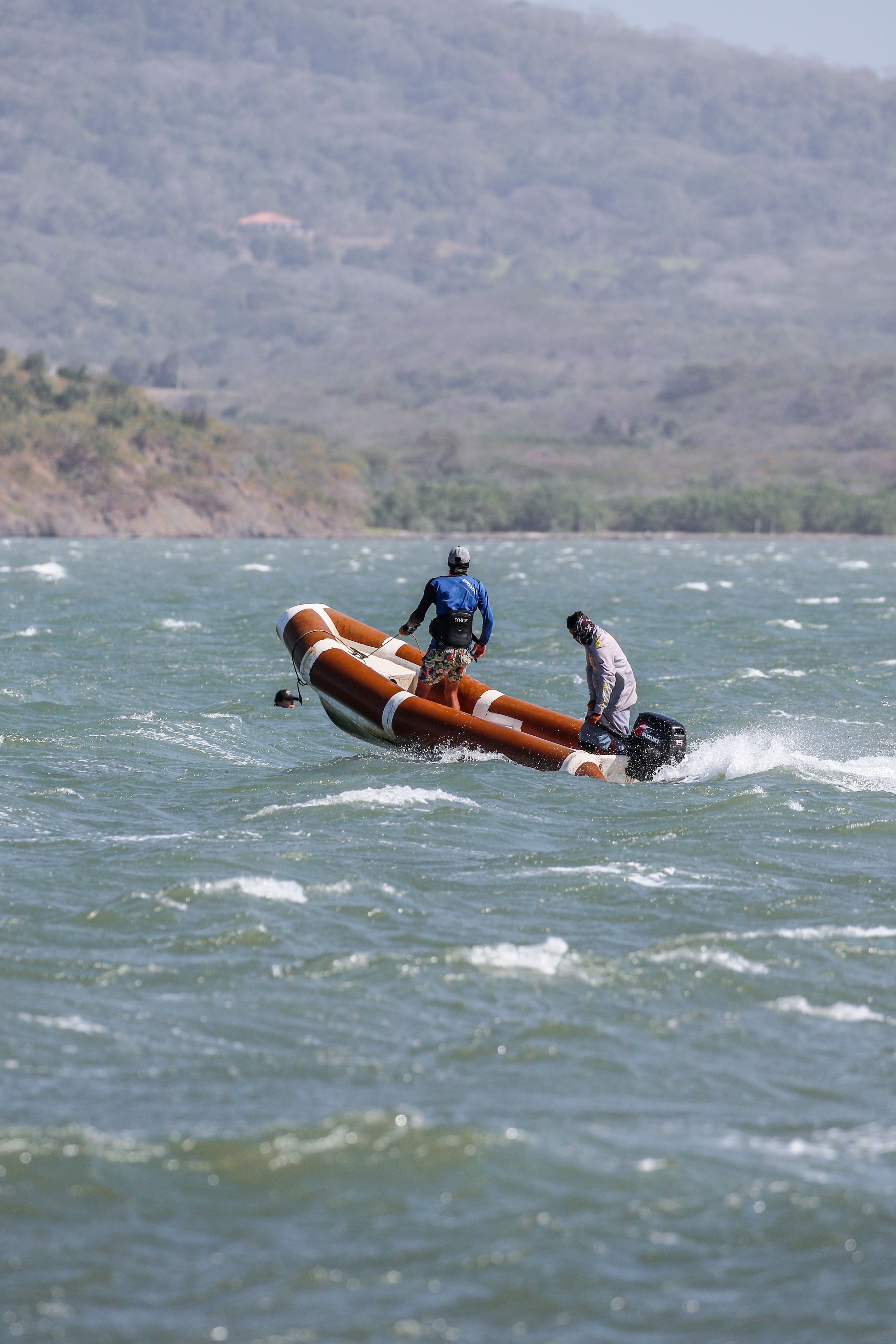 Two people riding on a small boat in the water · Free Stock Photo