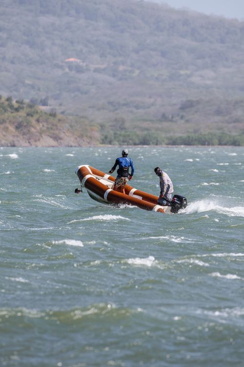 Two people riding on a small boat in the water · Free Stock Photo