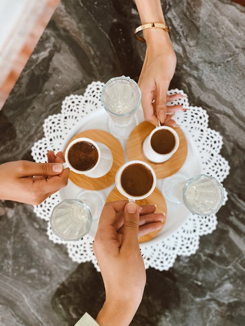 A group of people holding cups of coffee