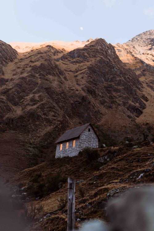 Free Cozy stone house nestled in the Andes mountains of Cusco, Peru, illuminated at dusk. Stock Photo