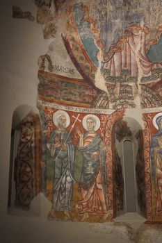 Detailed frescoes depicting saints inside a Barcelona monastery, showcasing Byzantine art.