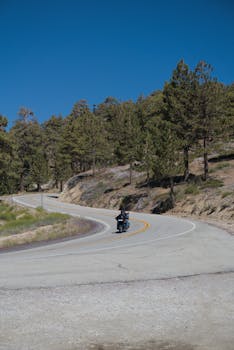 Lone motorcyclist on a winding mountain highway in Wrightwood, CA.