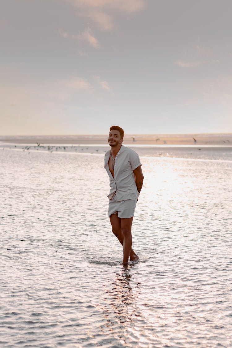 Man Wading Ankle-Deep In The Sea