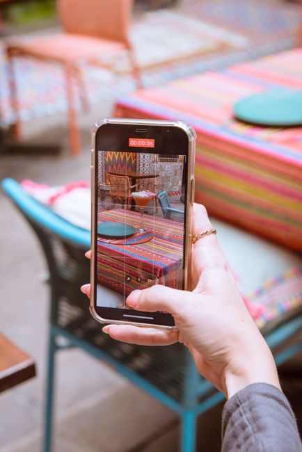 smartphone taking photo at outdoor cafe