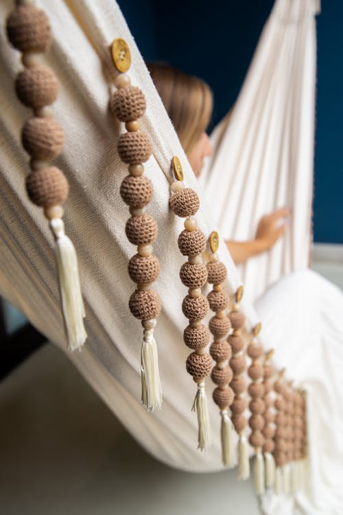 Woman Sitting in Hammock with Handmade Decorations