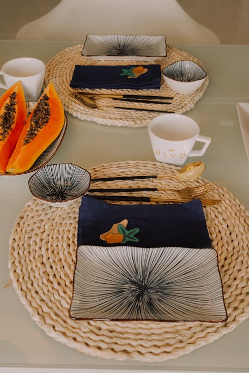 A table setting with plates, bowls and napkins