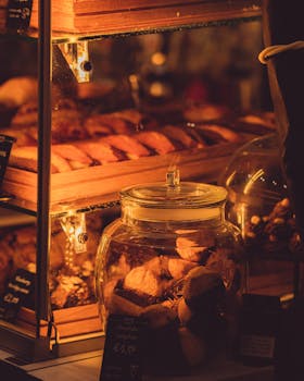 Cozy indoor bakery with freshly baked pastries and cookies in a glass jar.
