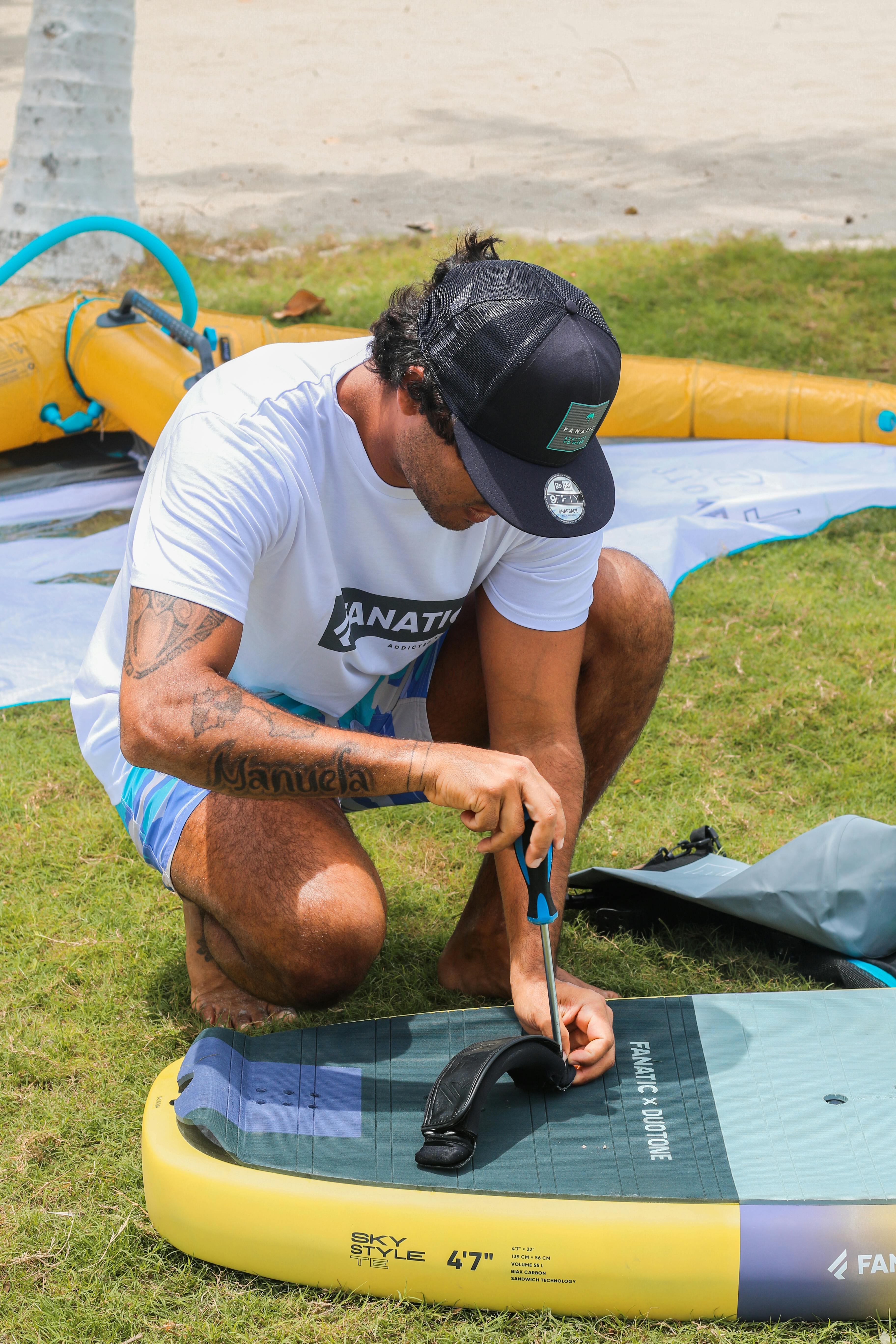 a man is kneeling down on a surfboard