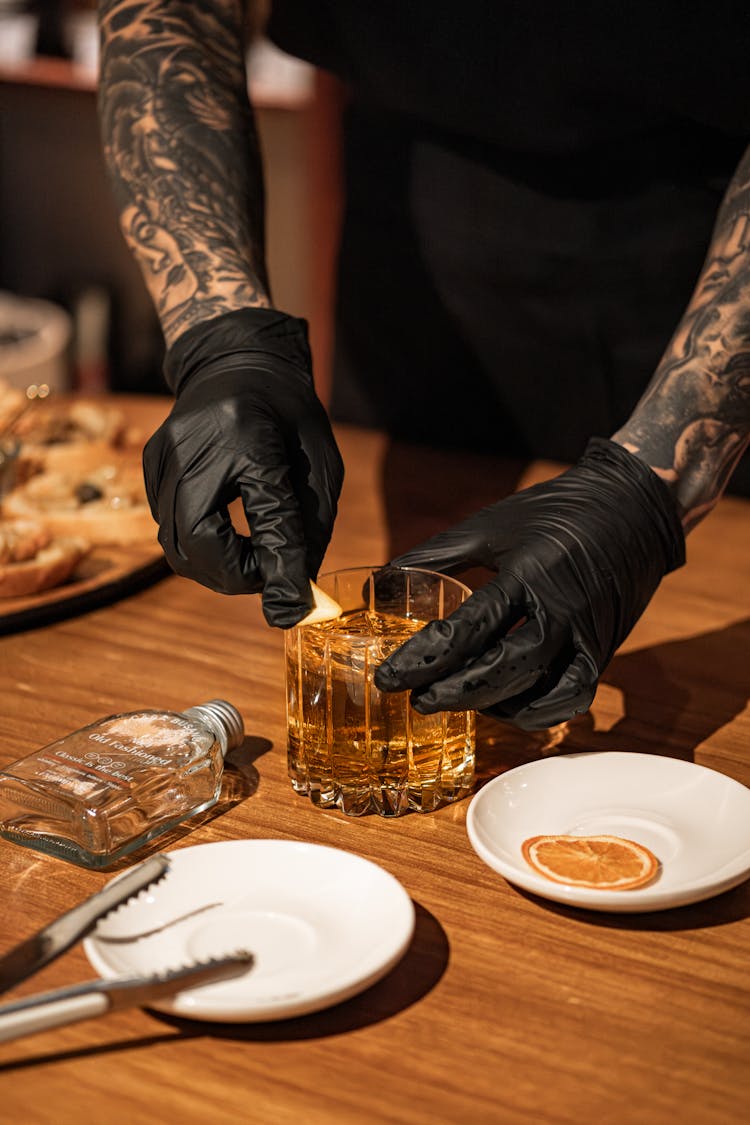 Man With Tattoos Preparing Drink