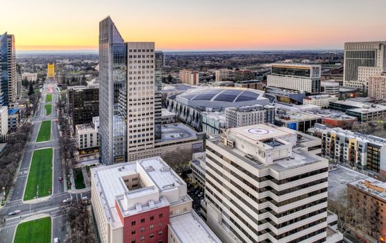 A captivating aerial view of Sacramento's urban skyline featuring modern architecture and sunset skies.