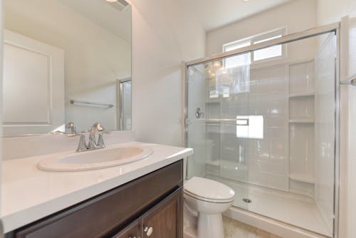 A bathroom with a shower, toilet and sink