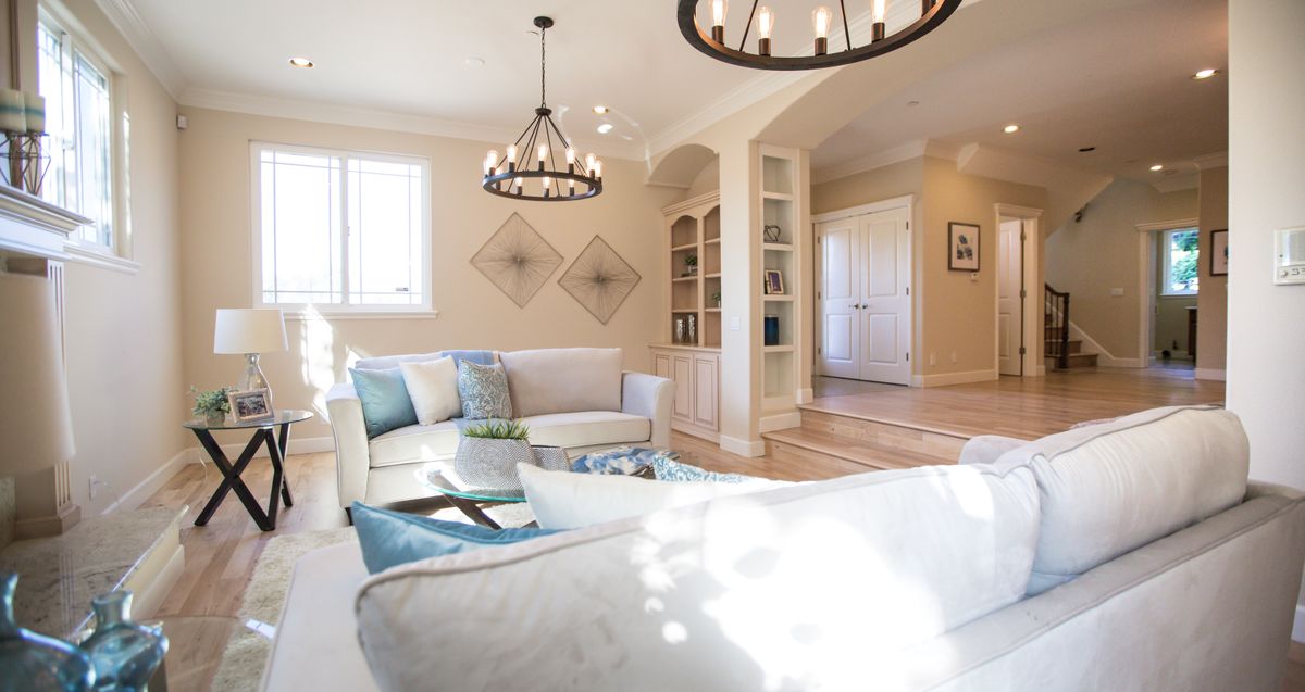 Elegant white Hamptons living room with a statement chandelier