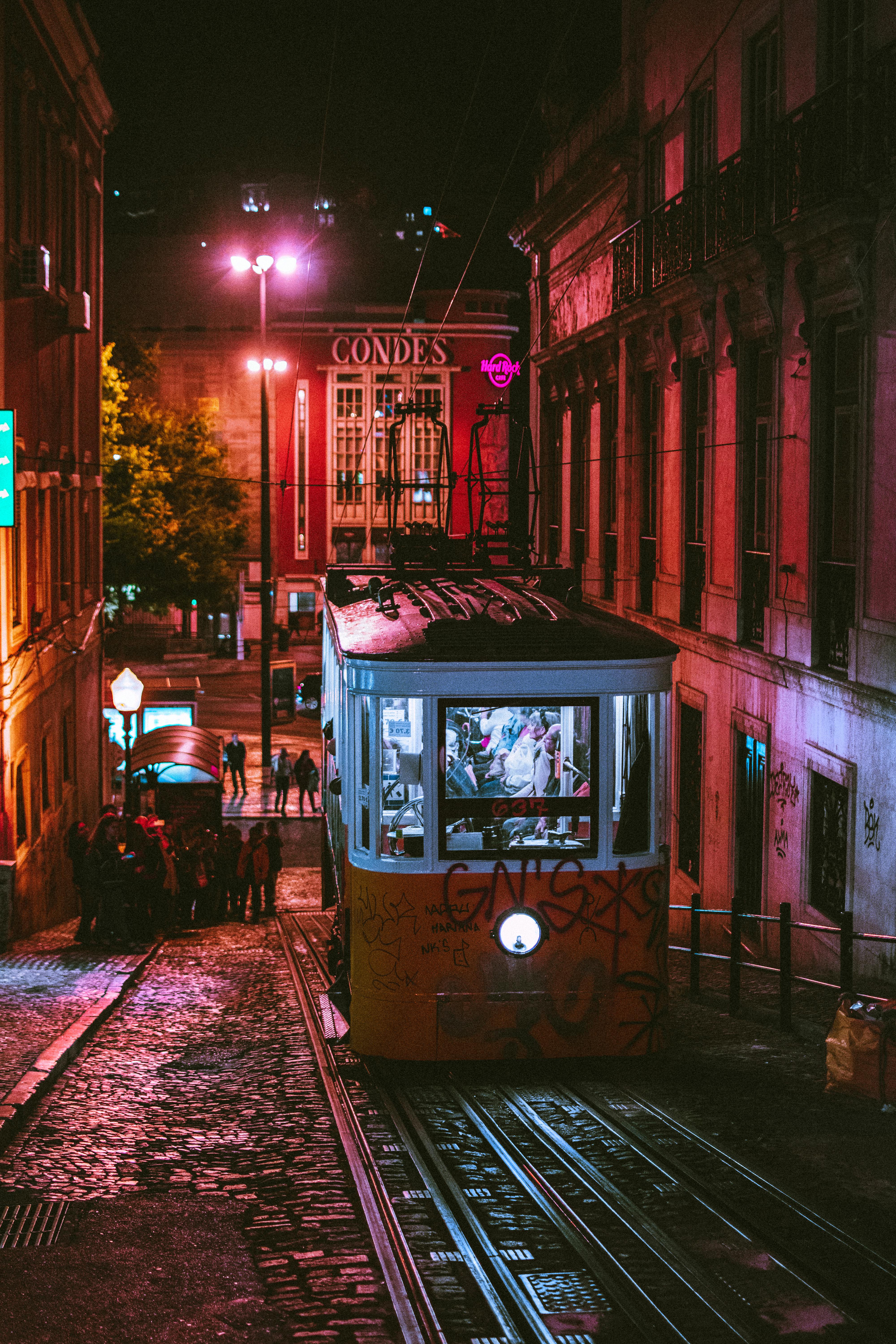 people riding tram at night