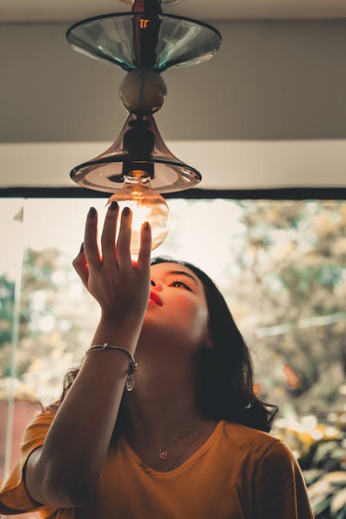 Photo Of Girl Touching Light Bulb