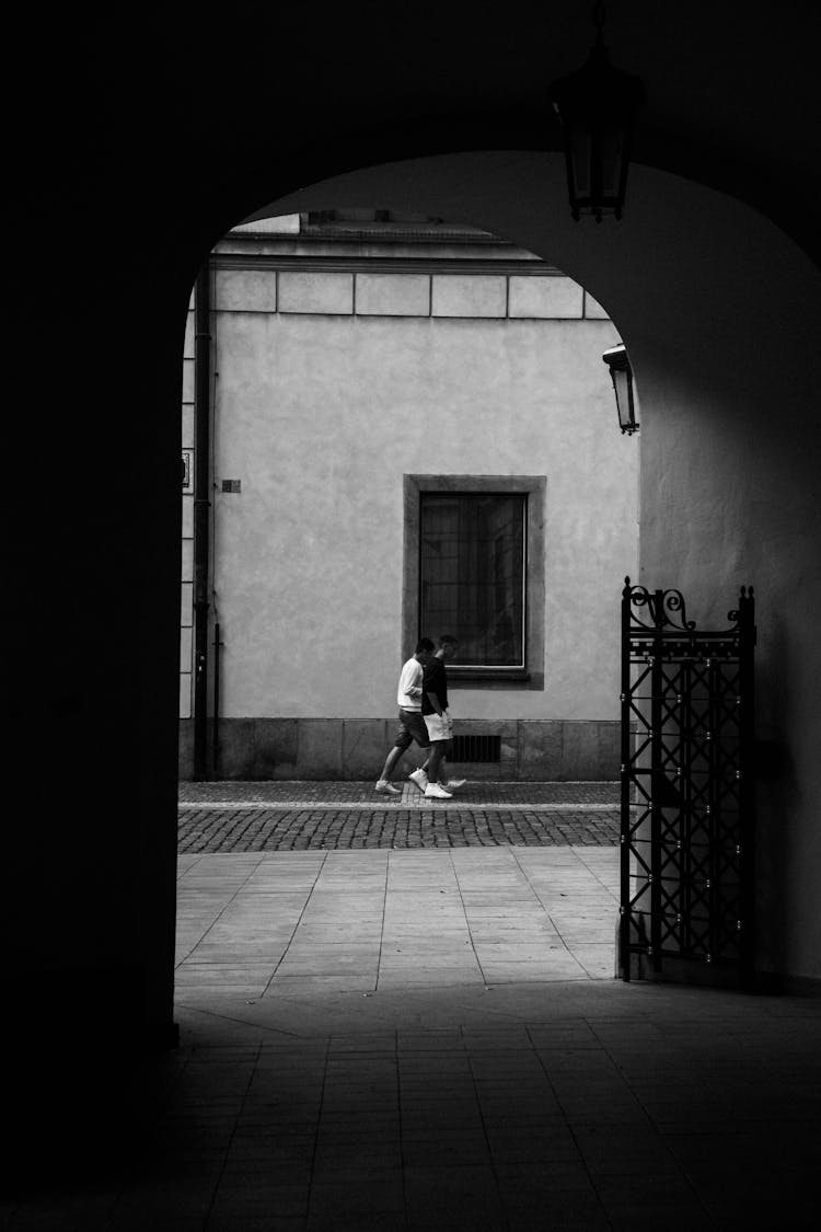 People Walking In Town In Black And White