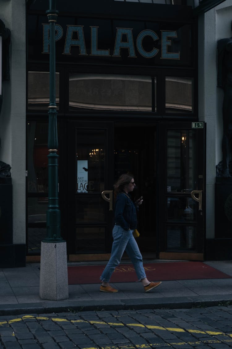 Woman Walking On Sidewalk