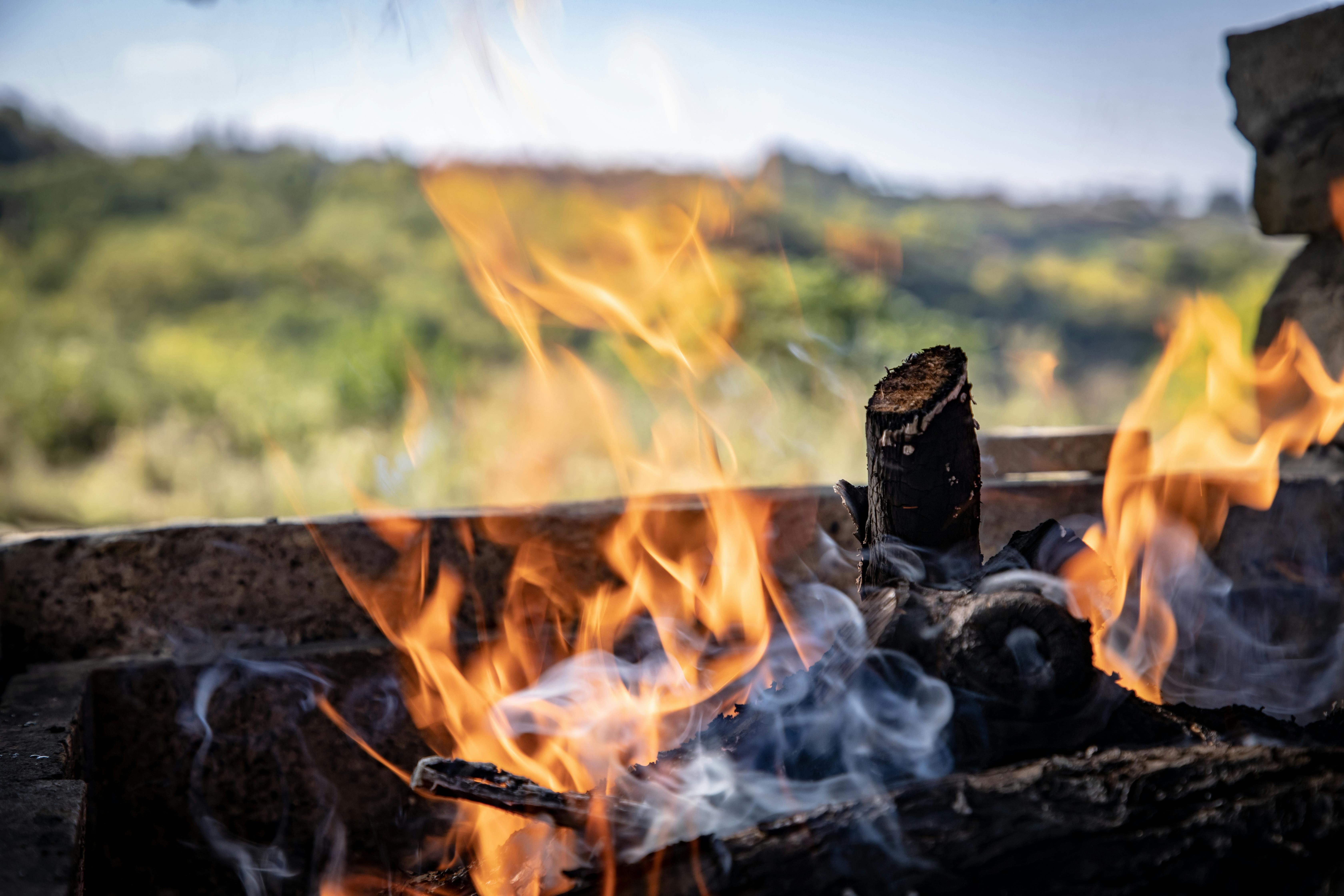 a fire is burning in the background with a view of the sky