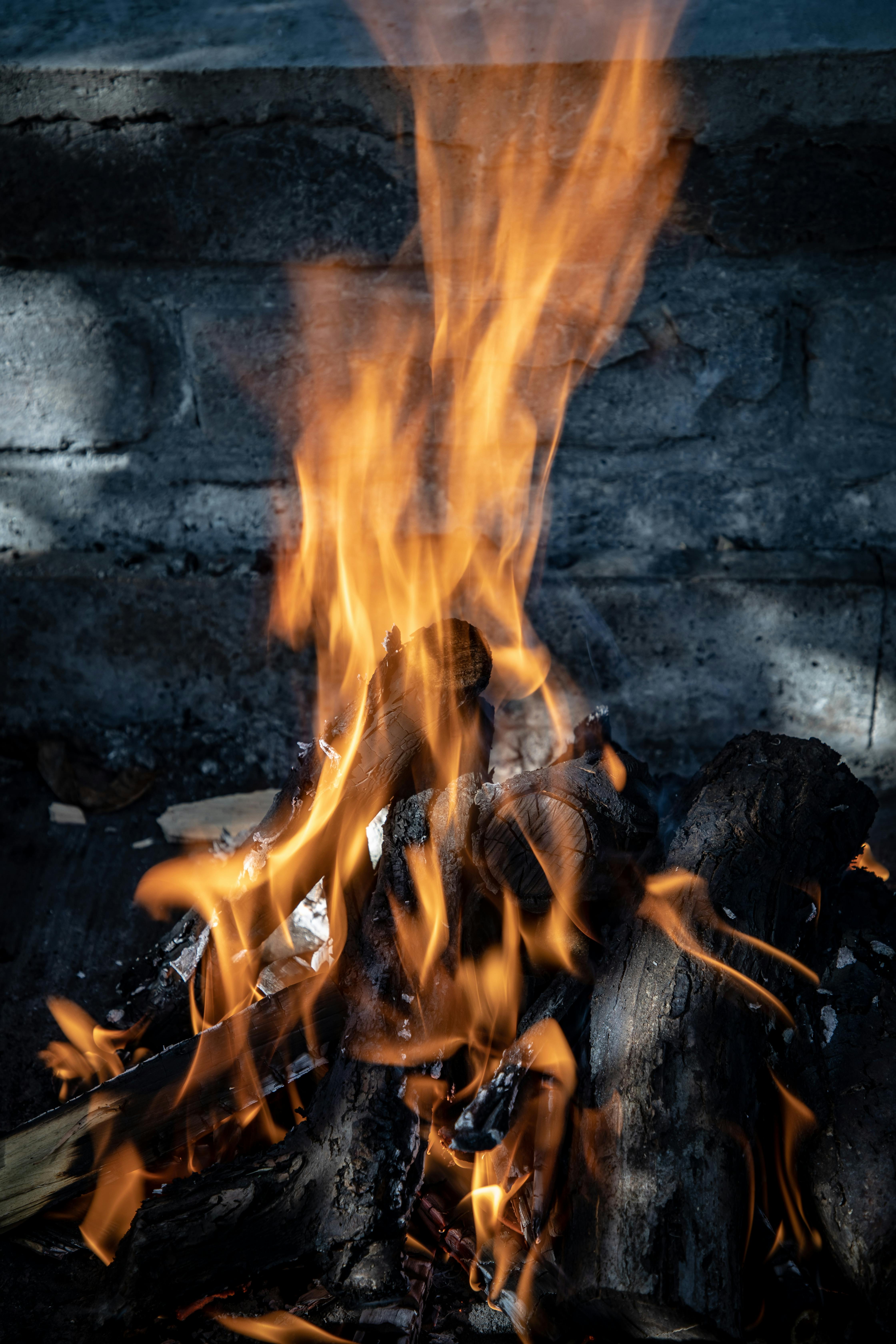 a fire is burning in the middle of a stone wall