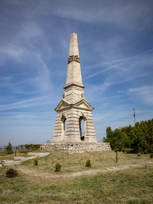 Free A majestic stone obelisk on a grassy hill under a clear blue sky during summer. Stock Photo