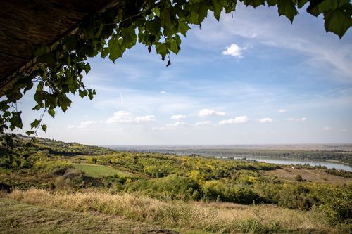 Free Idyllic summer landscape with a view of fields and a distant lake under a clear blue sky. Stock Photo
