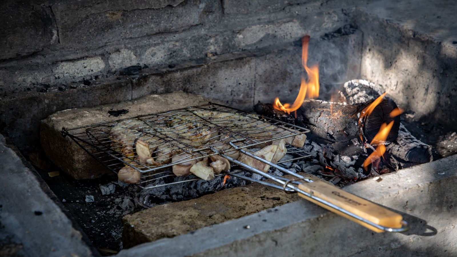 A grill with meat and vegetables on it, Eswatini